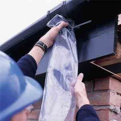 Man installing a Downpipe Sleeves